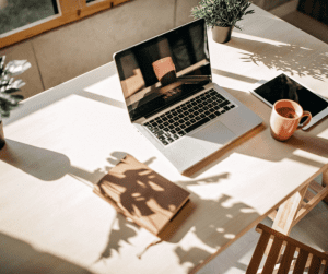 Laptop on desk with plant shadow