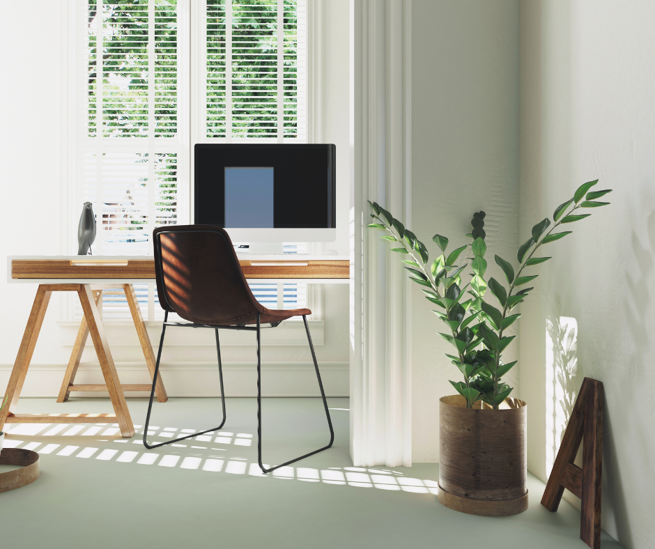 Desk with laptop by window with plant