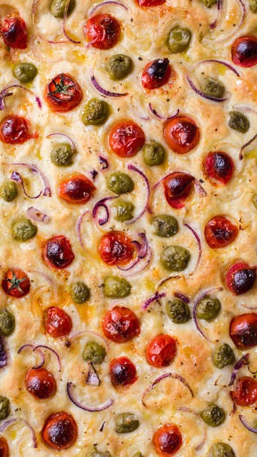 Focaccia bread with olives, tomatoes and cherry tomatoes